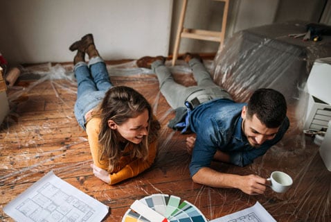 Couple reviews paint swatches and renovation plans.